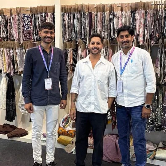 Founder Raj Kunwar Singh with two team members at the Queenz Fabrica stall